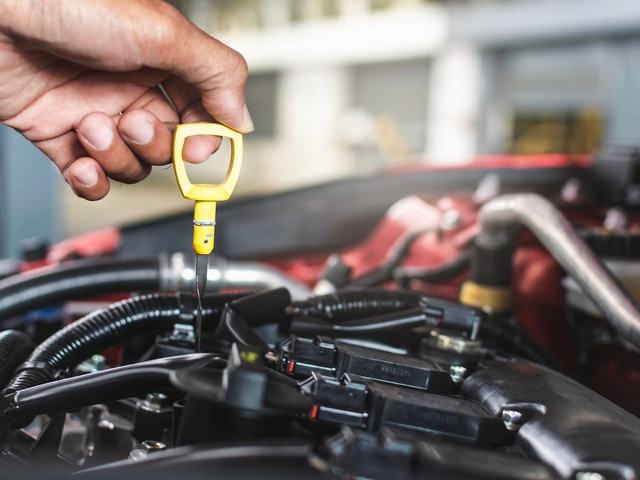 Engine oil being poured during a service